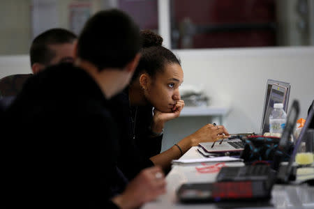 Student Jenna Diop, aged 20, works in her web development class as part of professional training at the Simplon.co school specialized in digital sector in Montreuil, near Paris, France, June 14, 2018. Picture taken June 14, 2018. REUTERS/Philippe Wojazer