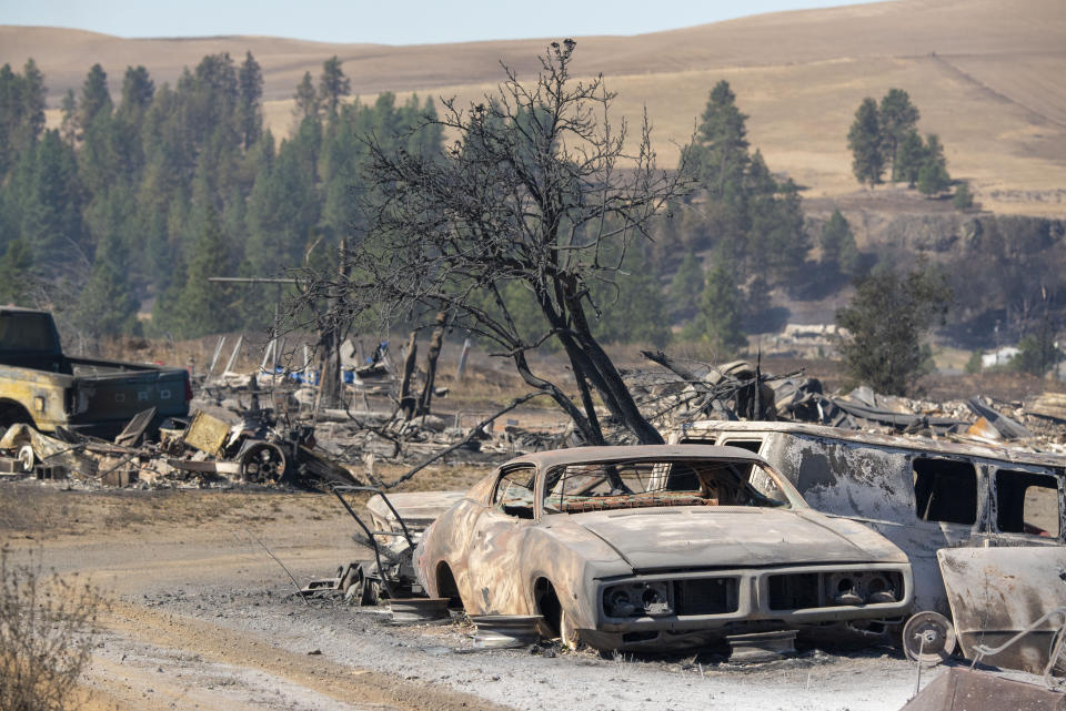 Vehicles are destroyed by a wildfire that swiftly moved through Maldin, Washington, on Tuesday. (Photo: ASSOCIATED PRESS)