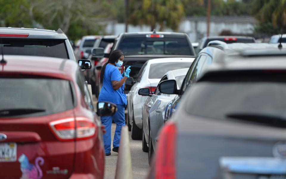 People waited more than four hours Thursday morning for COVID-19 testing at the state testing site at the Sarasota Kennel Club in Florida. (Mike Lang/Sarasota Herald-Tribune)