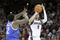 Gonzaga guard Julian Strawther (0) shoots while defended by Kentucky guard Sahvir Wheeler (2) during the first half of an NCAA college basketball game, Sunday, Nov. 20, 2022, in Spokane, Wash. (AP Photo/Young Kwak)