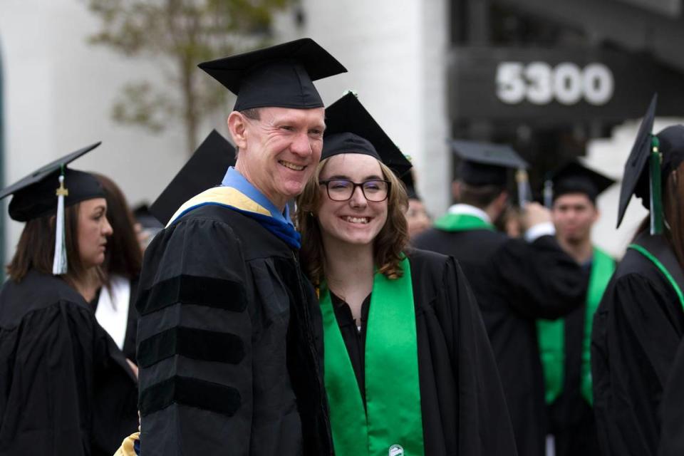 Cuesta College held its 59th commencement ceremony at the San Luis Obispo campus on Friday, May 17, 2024. Heather Martone Bogle, an administration of justice graduate, poses for a photo with philosophy professor Chris Gilbert.