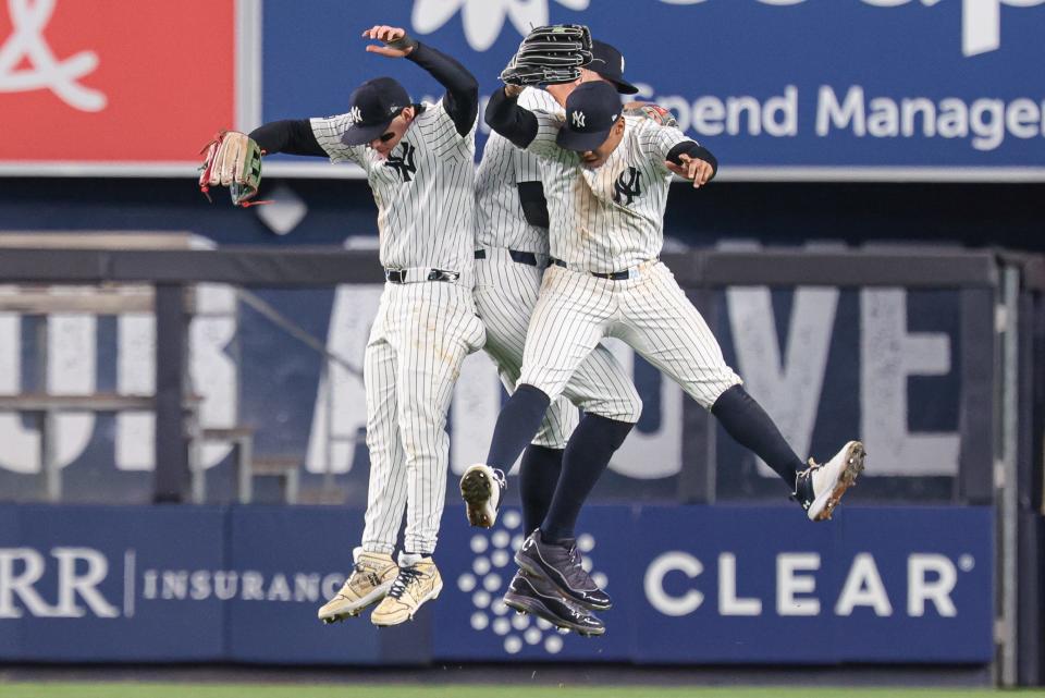 Apr 9, 2024; Bronx, New York, USA; New York Yankees left fielder Alex Verdugo (24) and center fielder Aaron Judge (99) and right fielder Juan Soto (22) celebrates after drafting the Miami Marlins at Yankee Stadium. Mandatory Credit: Vincent Carchietta-USA TODAY Sports