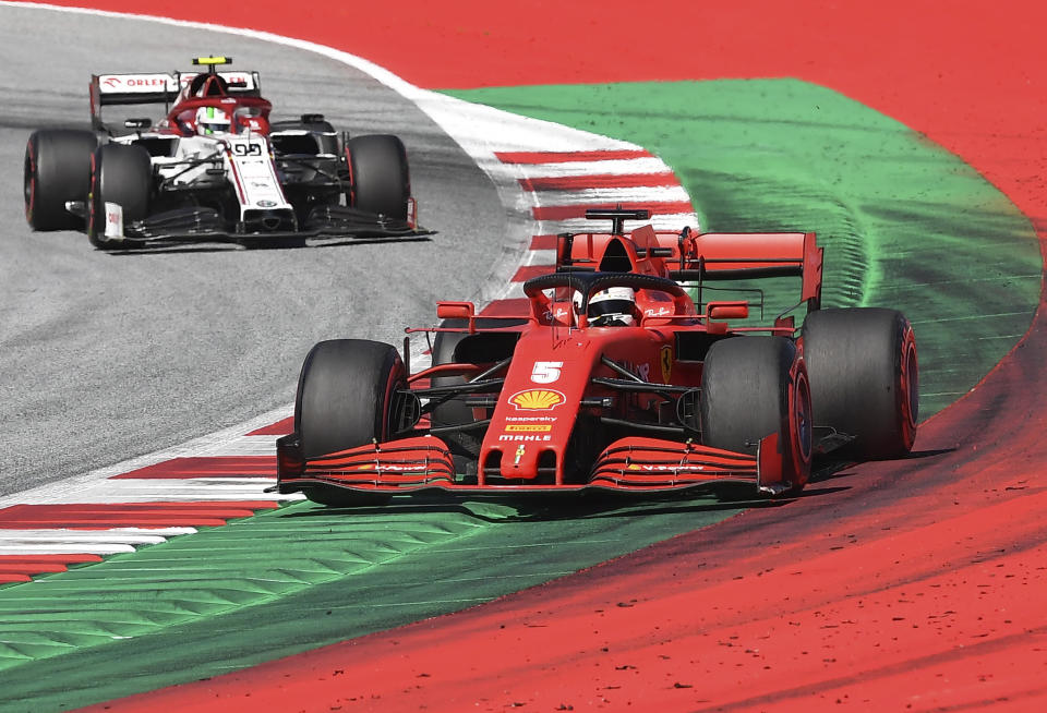 El piloto de Ferrari Sebastian Vettel conduce su monoplaza por delante del Alfa Romeo del italiano Antonio Giovinazzi durante el Gran Premio de Austria en el circuito de Spielberg, el domingo 5 de julio de 2020. (Joe Klamar/Pool vía AP)