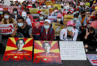 Demonstrators display placards with pictures of deposed Myanmar leader Aung San Suu Kyi and a sign that shows CDM, promoting "Civil Disobedience Movement" to protest against the military coup in Yangon, Myanmar, Wednesday, Feb. 17, 2021. The U.N. expert on human rights in Myanmar warned of the prospect for major violence as demonstrators gather again Wednesday to protest the military's seizure of power. (AP Photo)