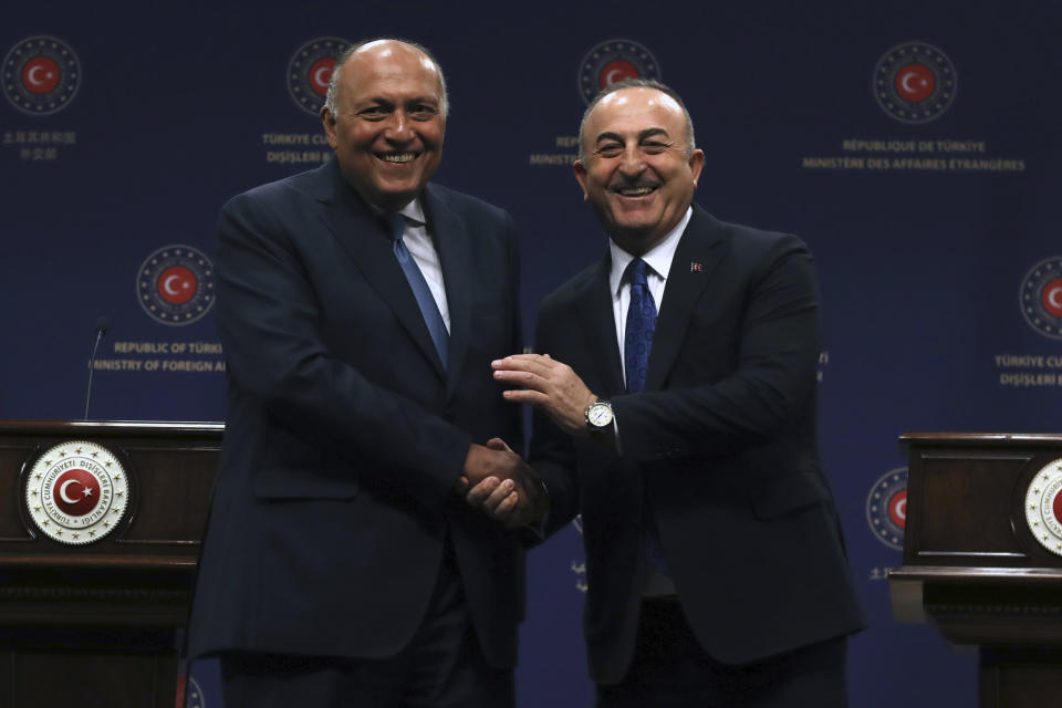 Turkish Foreign Minister Mevlut Cavusoglu, right, and his Egyptian counterpart Sameh Shoukry shake hands after a joint news conference, in Ankara, Turkey, Thursday, April 13, 2023. Shoukry is in Turkey as the two countries attempt to improve relations. (AP Photo/Burhan Ozbilici)