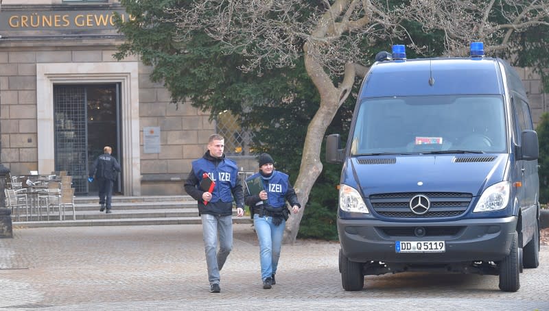 Police offciers leave Green Vault city palace after a robery in Dresden