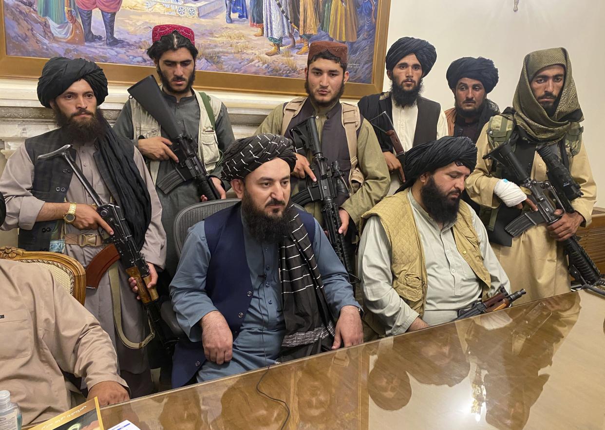 Taliban fighters take control of the Afghan presidential palace after Afghan President Ashraf Ghani fled the country, in Kabul, Afghanistan on Sunday, Aug. 15, 2021.