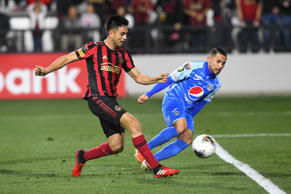 Atlanta United's Gonzalo Martinez, left, knocks the ball in for a goal as Motagua's Omar Elvir defends during the second half of CONCACAF Champions League soccer match Tuesday, Feb. 25, 2020, in Kennesaw, Ga. (John Amis/Atlanta Journal-Constitution via AP)