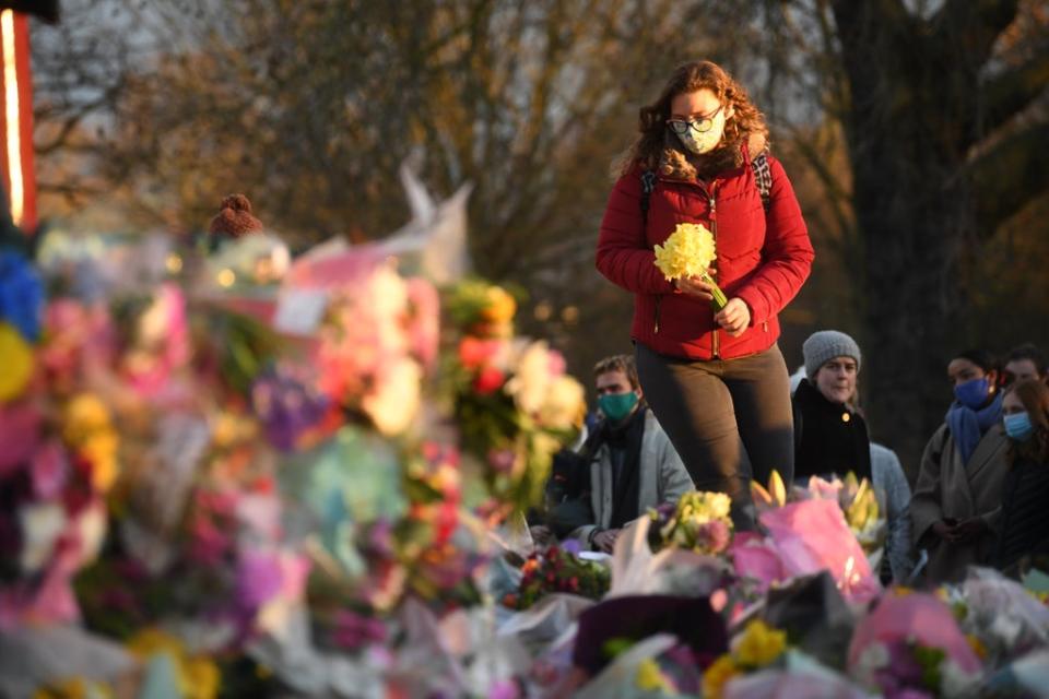 A woman places flowers in tribute to Sarah Everard, whose rape and murder by off-duty police officer Wayne Couzens in March, sparked the report (Victoria Jones/PA) (PA Archive)