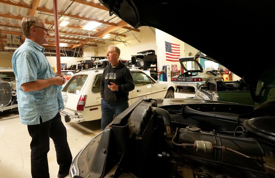 David Neel, left, executive director of the Murphy Auto Museum in Oxnard, talks with Fireball Time Lawrence, director of automotive art, on April 15. The museum has been open since 2002 but will close in July. It is the second car museum to shutter in Oxnard this year.