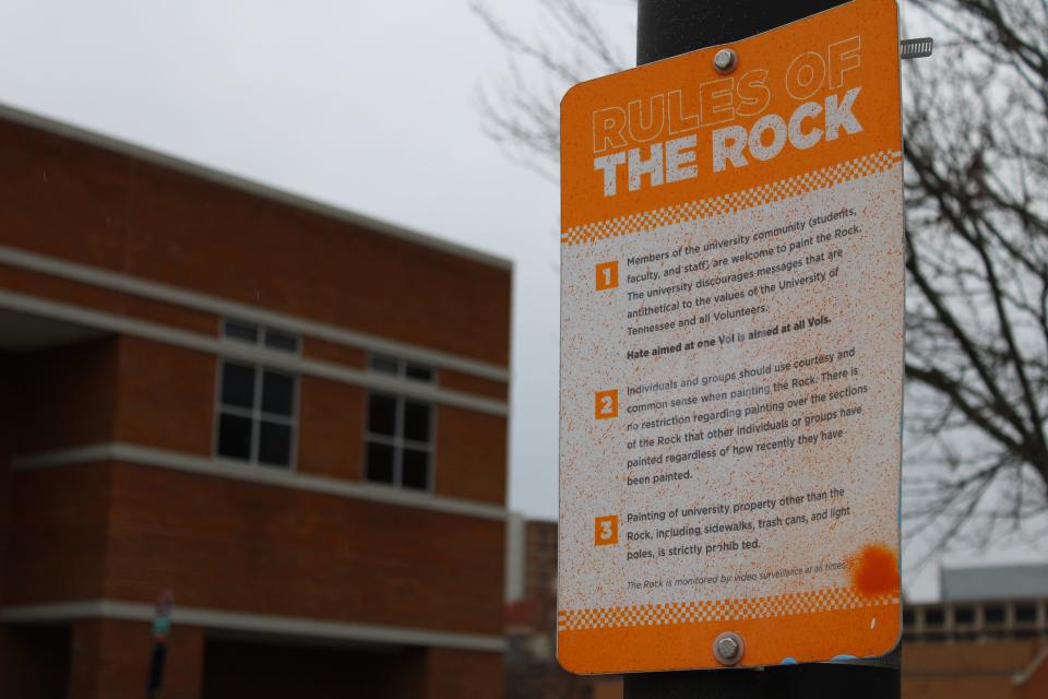 A sign attached to a lamppost lays out the "Rules of the Rock." The rules apply for the Rock next to the sign, which symbolizes free speech on campus.