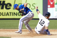 New York Yankees' Isiah Kiner-Falefa (12) slides safely into second base past Kansas City Royals second baseman Whit Merrifield during the fifth inning of a baseball game, Saturday, July 30, 2022, in New York. (AP Photo/Mary Altaffer)