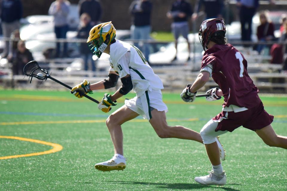 Kyle Hardie,#10, of Morris Knolls moves with the ball as Connor Ross, #1, of Morristown pressures him in the first half during the Rizk boys lacrosse game at Morris Knolls High in Denville, Monday on 04/11/22.