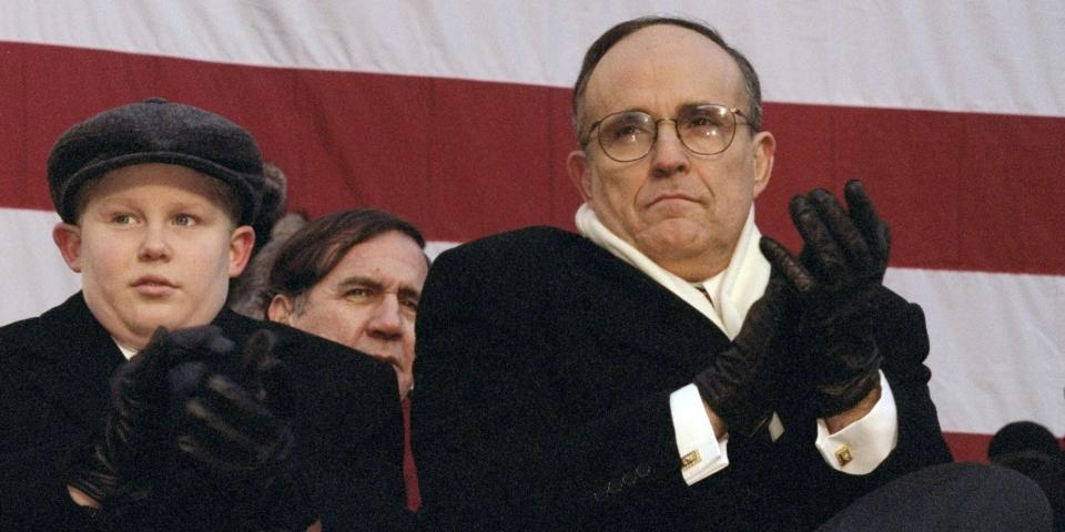 Former New York City Mayor Rudy Giuliani sits with his son Andrew at City Hall during his inauguration for a second term at City Hall.