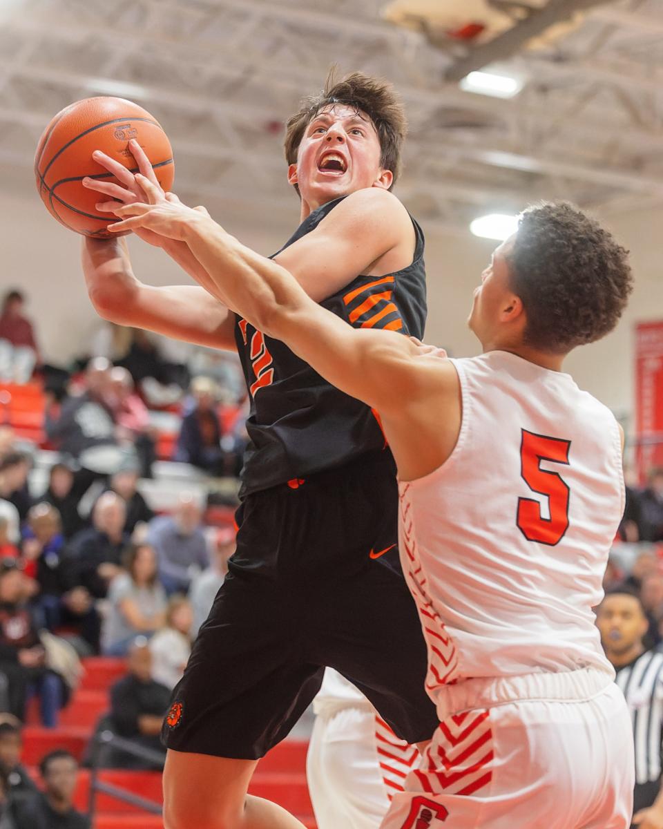 Brighton's Trevor Viau puts up an off-balance shot while defended by Canton's Caleb Williams during the Bulldogs' 67-45 loss on Friday, Feb. 17, 2023.