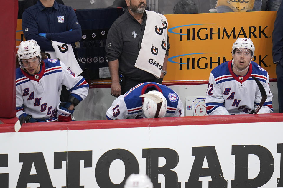 New York Rangers' Alexis Lafrenière (13) sits on the bench between Artemi Panarin (10) and Filip Chytil late in the third period in Game 3 of an NHL hockey Stanley Cup first-round playoff series in Pittsburgh, Saturday, May 7, 2022. (AP Photo/Gene J. Puskar)