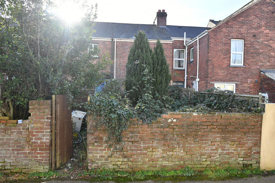 The overgrown garden at an address in Exeter, where the body of a man was found. (PA Images)