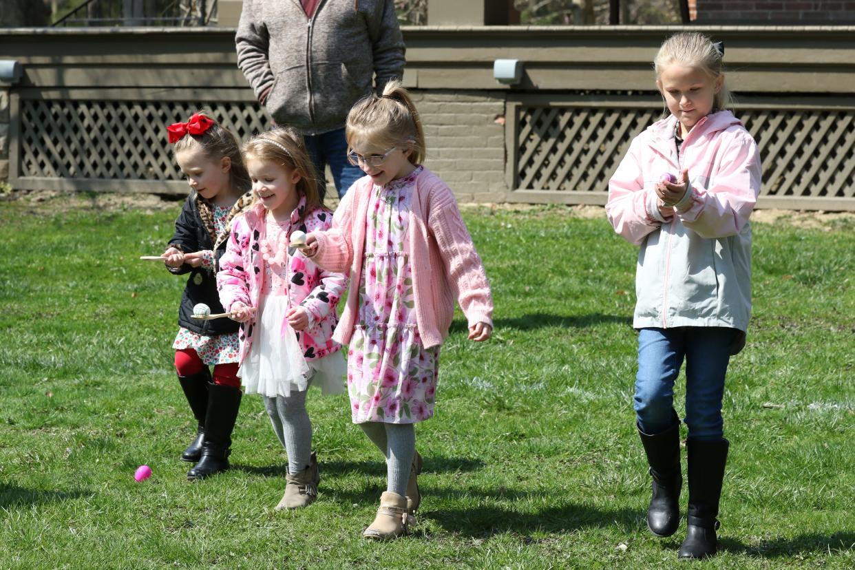 From left, Ainsley Hoste, 4, joins her cousins Kalli Bruner, 5, and Kenna Bruner, 7, along with her sister Sawyer Hoste, 7, at the annual Hayes Easter Egg Roll, on Saturday at Spiegel Grove. The girls all made the trip from Wauseon with their parents.