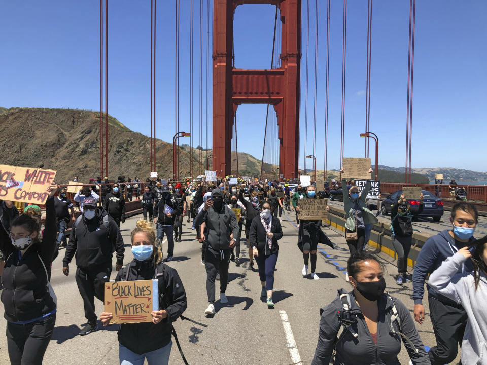 Dozens of people march across the Golden Gate Bridge in support of the Black Lives Matter movement in San Francisco Saturday, June 6, 2020. People are protesting the death of George Floyd, who died after he was restrained by Minneapolis police on May 25 in Minnesota. (AP Photo/Jeff Chiu)