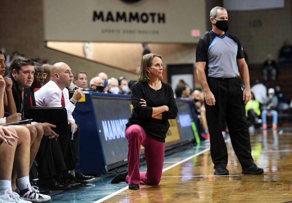 South Dakota head coach Dawn Plitzuweit watches the game while taking a knee on the sideline during a matchup against South Carolina on Friday, November 12, 2021, at the Sanford Pentagon in Sioux Falls.