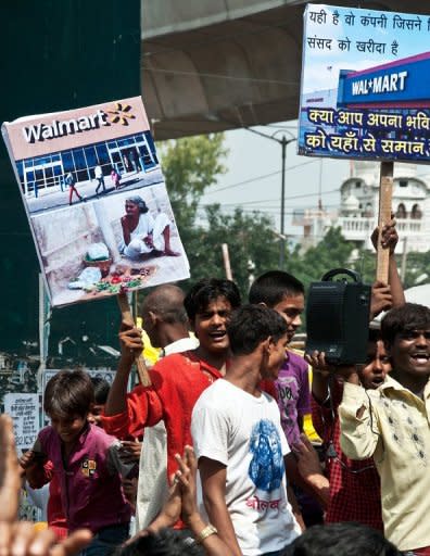 Indian vendors hold placards denouncing Walmart during a strike at the Azadpur wholesale vegetable and fruit market in New Delhi on September 20. Up until now foreign groups such as Walmart could only operate as wholesalers amid fears that big Western retail chains would swamp India's tens of millions of small family-run stores which dominate the sector