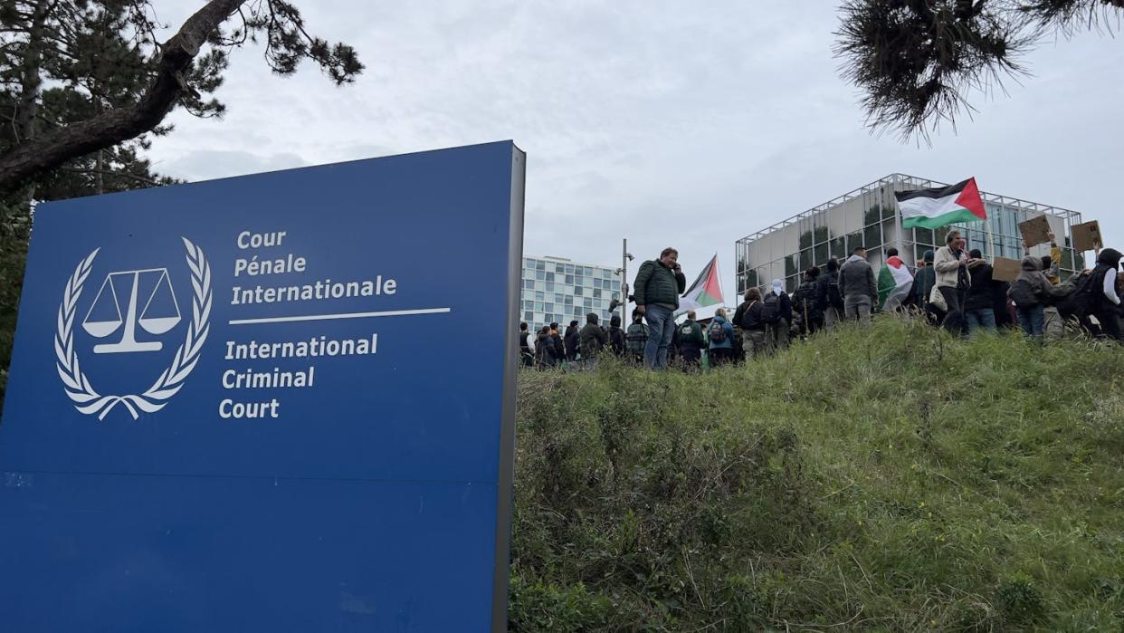 People carrying Palestinian flags and banners gather in front of the International Criminal Court on Oct. 18, 2023. <a href="https://www.gettyimages.com/detail/news-photo/the-signboard-of-international-criminal-court-is-seen-as-news-photo/1731500360?adppopup=true" rel="nofollow noopener" target="_blank" data-ylk="slk:Abdullah Asiran/Anadolu via Getty Images;elm:context_link;itc:0;sec:content-canvas" class="link ">Abdullah Asiran/Anadolu via Getty Images</a>