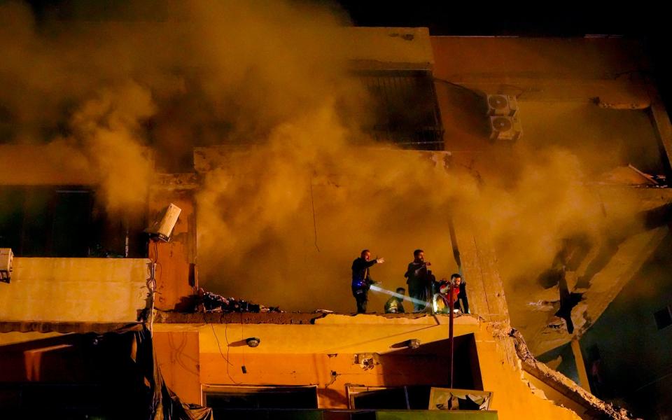 Smoke rises from a destroyed apartment as civil defense workers search for survivors following a massive explosion in the southern Beirut suburb of Dahiyeh, Lebanon, Tuesday, Jan. 2, 2024. An explosion killed Saleh Arouri, a top official with the Palestinian militant group Hamas and three others, officials with Hamas and the Lebanese group Hezbollah said.