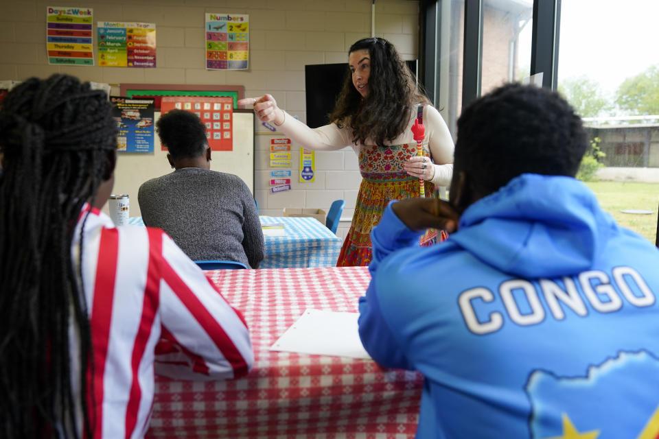 Lutheran Services Carolinas outreach coordinator supervisor Sarah Lewis, center, teaches an English class for recently arrived refugees, Thursday, April 11, 2024, in Columbia, S.C. The American refugee program, which long served as a haven for people fleeing violence around the world, is rebounding from years of dwindling arrivals under former President Donald Trump. The Biden administration has worked to restaff refugee resettlement agencies and streamline the process of vetting and placing people in America. (AP Photo/Erik Verduzco)