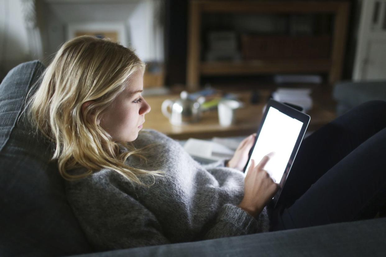 A 18 years old young woman with a tablet computer