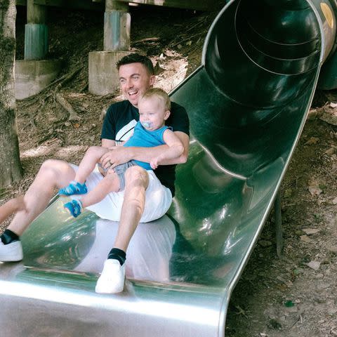 <p>Frankie Muniz Instagram</p> Frankie Muniz going down a slide with his son Mauz Mosley Muniz in March 2023