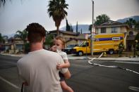 <p>A toddler covers his nose at the Holy Fire in Lake Elsinore, California, southeast of Los Angeles on Aug. 10, 2018. (Photo: Robyn Beck/AFP/Getty Images) </p>