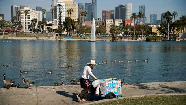 PHOTO: A vendor wheels around an ice cream cart in MacArthur Park in Los Angeles, Sept. 1, 2022. (Caroline Brehman/EPA via Shutterstock)
