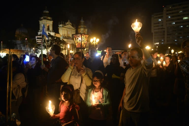 People take part in a demonstration demanding the resignation of Guatemalan President Otto Perez, as a corruption scandal rocks the government, in Guatemala City, on July 4, 2015