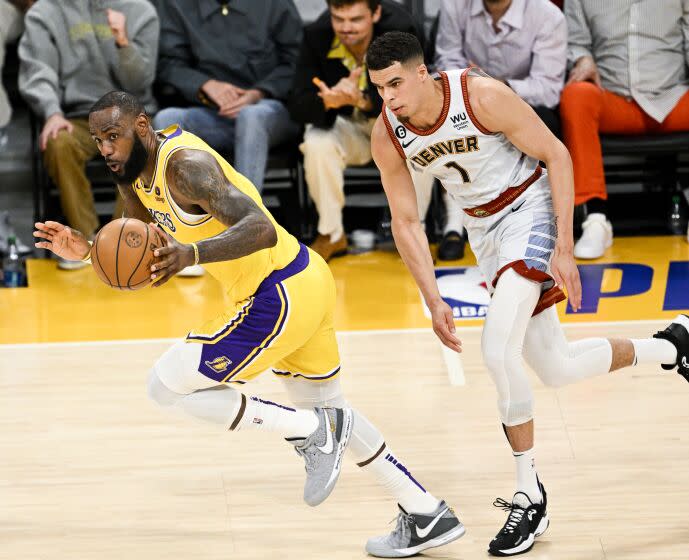 LOS ANGELES, CA - MAY 22: Los Angeles Lakers forward LeBron James, left, handles the ball on a fast break.