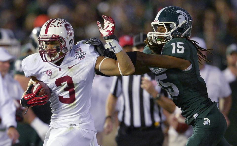 Stanford wide receiver Michael Rector tries to break a tackle by Michigan State cornerback Trae Waynes during the second half of the Rose Bowl NCAA college football game Wednesday, Jan. 1, 2014, in Pasadena, Calif. (AP Photo/Mark J. Terrill)