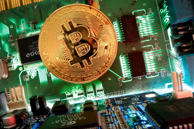 FILE PHOTO: Representation of the virtual currency Bitcoin is seen on a motherboard in this picture illustration