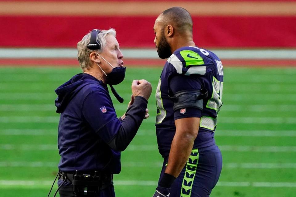 Seattle Seahawks head coach Pete Carroll talks with outside linebacker K.J. Wright during the first half of an NFL football game, Sunday, Jan. 3, 2021, in Glendale, Ariz. (AP Photo/Rick Scuteri)