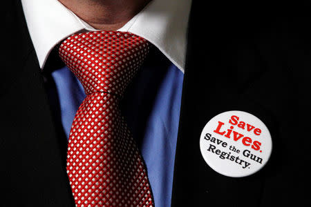 FILE PHOTO: Liberal Member of Parliament Mark Holland sports a pin supporting the long-gun registry while speaking to journalists in the foyer the House of Commons on Parliament Hill in Ottawa, Ontario, Canada, September 22, 2010. REUTERS/Chris Wattie/File Photo