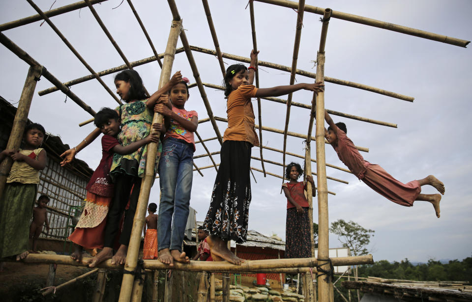 In This Monday, Aug. 27, 2018, file photo, Rohingya refugee children play at a hand water pump at Balukhali Refugee Camp in Bangladesh. Investigators working for the U.N.'s top human rights body said Monday that Myanmar military leaders should be prosecuted for genocide against Rohingya Muslims, taking the unusual step of identifying six by name among those behind deadly, systematic crimes against the ethnic minority. (AP Photo/Altaf Qadri, File)