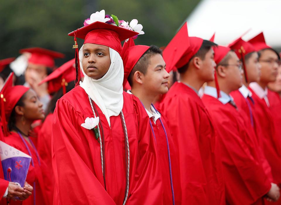 Sulekha Hussein looks for her family in the stands during North Quincy High School's commencement ceremony at Veterans Memorial Stadium on Tuesday, June 6, 2023.