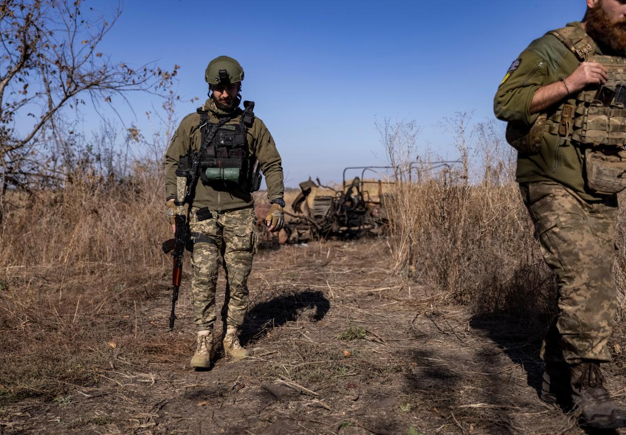 Soldiers walk along a position near the frontline in the Donetsk region (REUTERS)