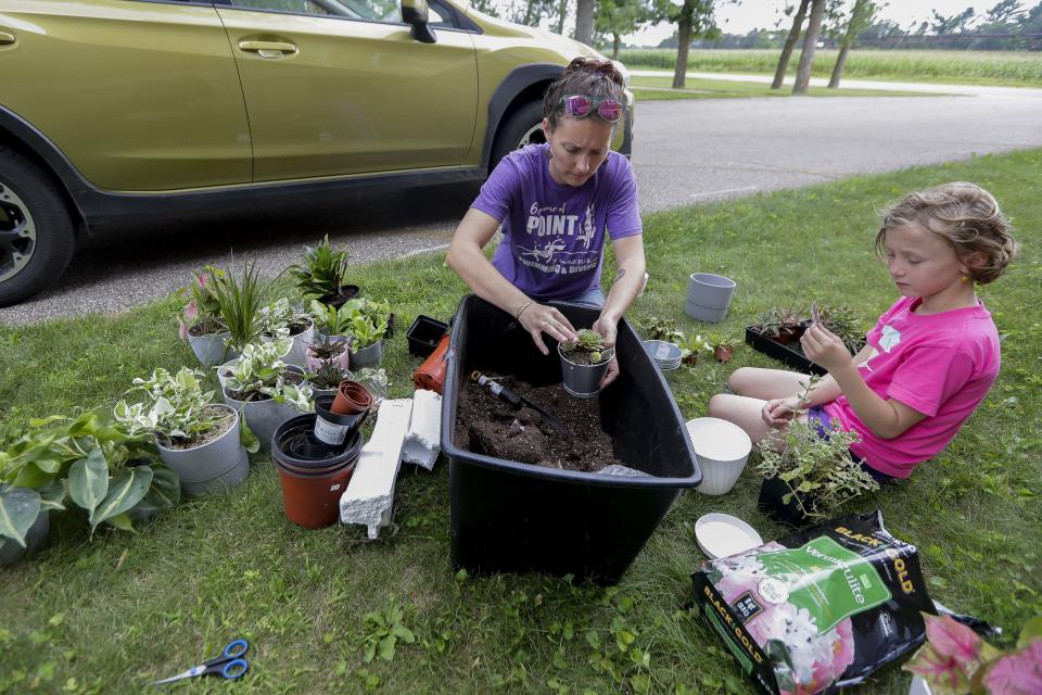 Director Amy Boelk and her daughter, Nora Schmied, pot plants on Aug. 3 at Central Sands Community High School near Amherst Junction. The school, which is in the converted Fancher schoolhouse, will open this fall.