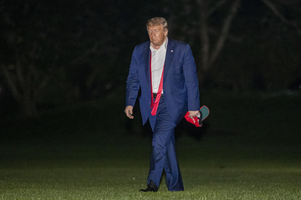 President Donald Trump, returning from a campaign rally in Tulsa, Okla., walks across the South Lawn of the White House in Washington after stepping off the Marine One helicopter, early Sunday, June 21, 2020. (AP Photo/Patrick Semansky)