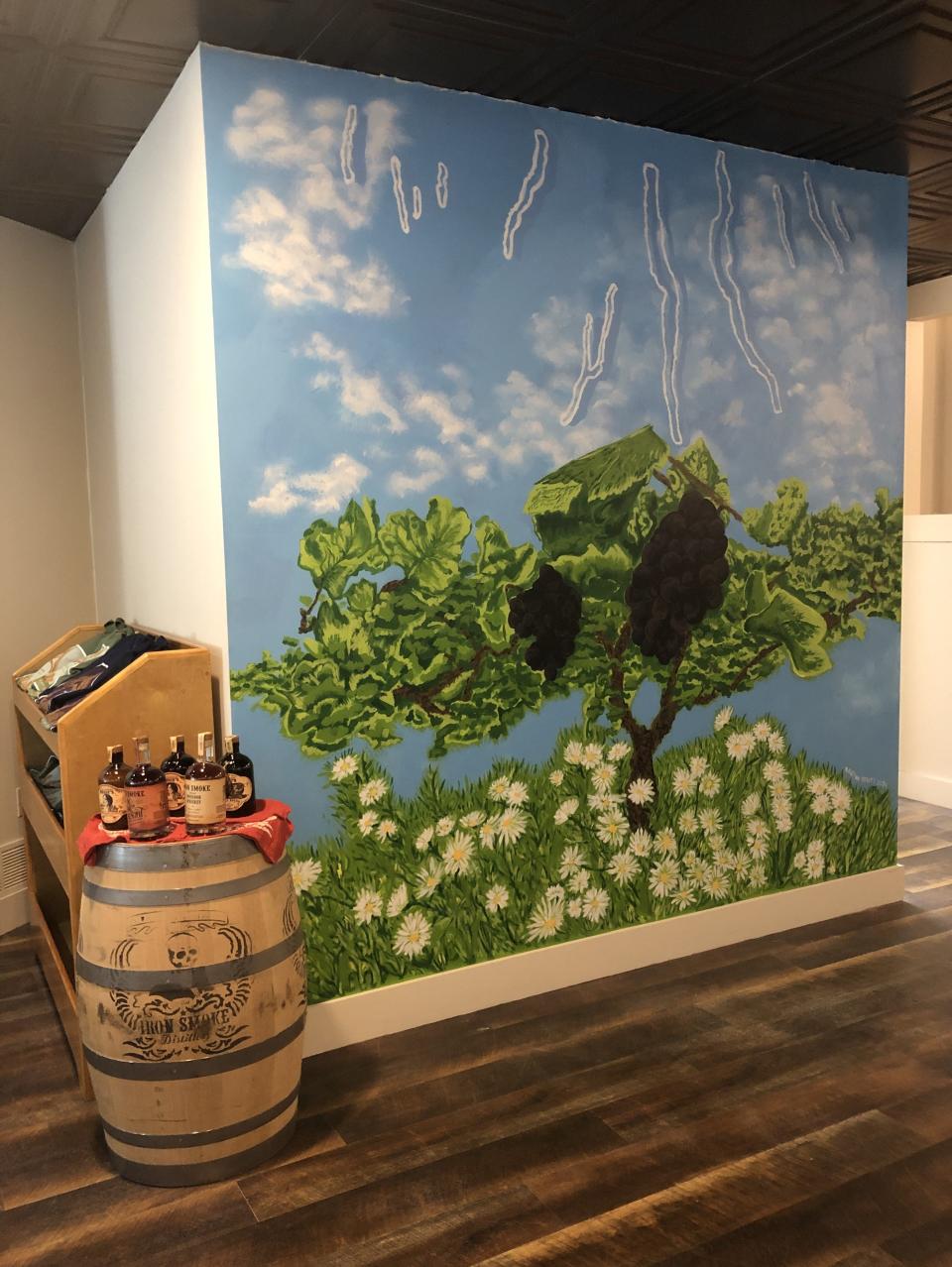 A mural adorns one of the spots in the spacious Acquilano Wine Cellars tasting room, which takes over the space that Aubergine once occupied in downtown Canandaigua.