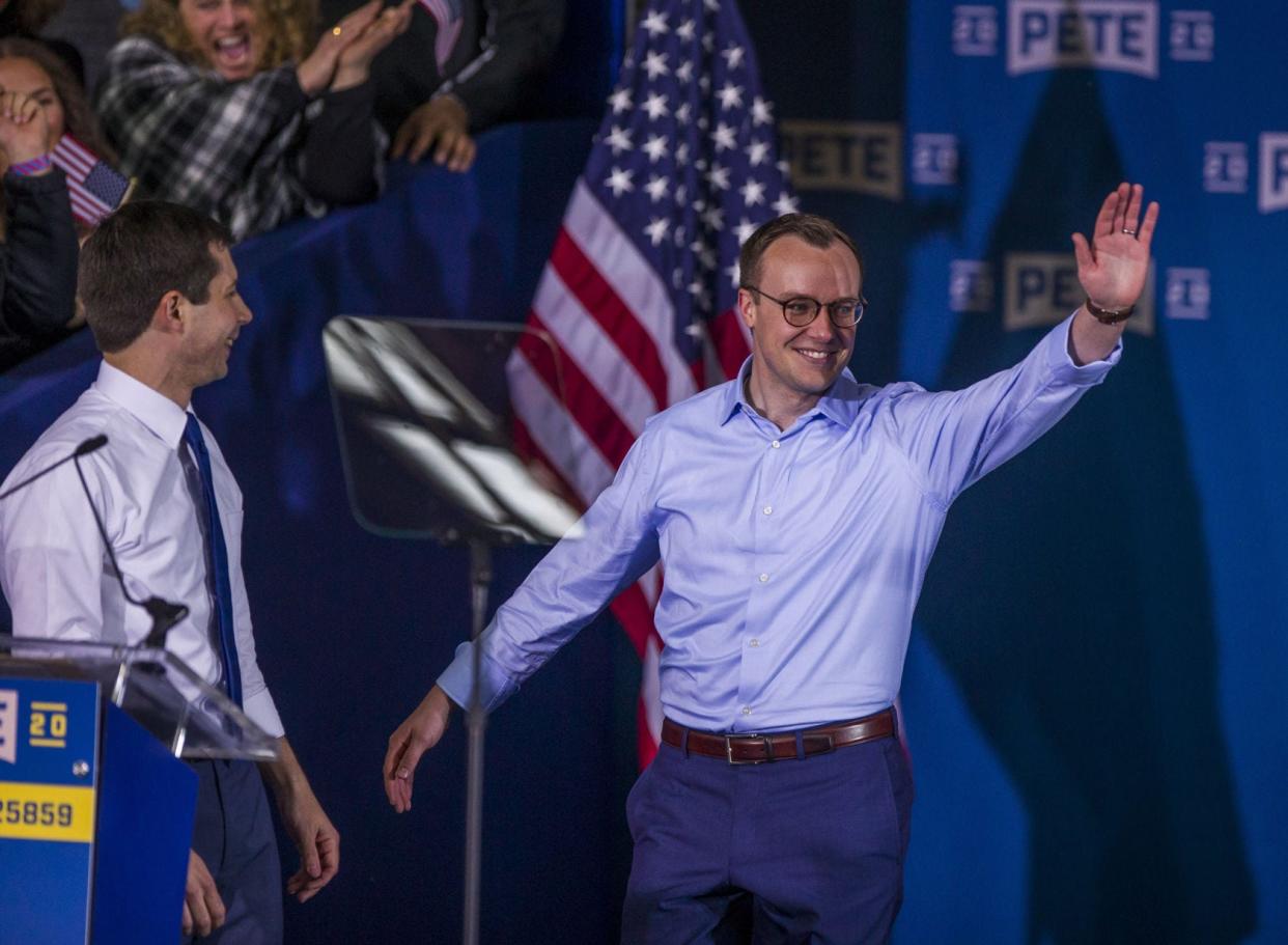 Chasten Buttigieg, right, waves to the crowd as he is introduced on stage by his husband, Pete, after the mayor’s announcement of a run for president. Tribune File Photo