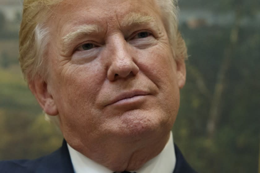 President Donald Trump listens to a presentation in the Roosevelt Room of the White House in Washington. 