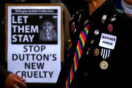 Refugee advocates hold signs and wear messages on their clothes as they protest against the detention of asylum seekers being held at Australian-run offshore detention centers located on Papua New Guinea's Manus Island, and the South-Pacific island of Nauru, in central Sydney, Australia, August 31, 2017. REUTERS/David Gray