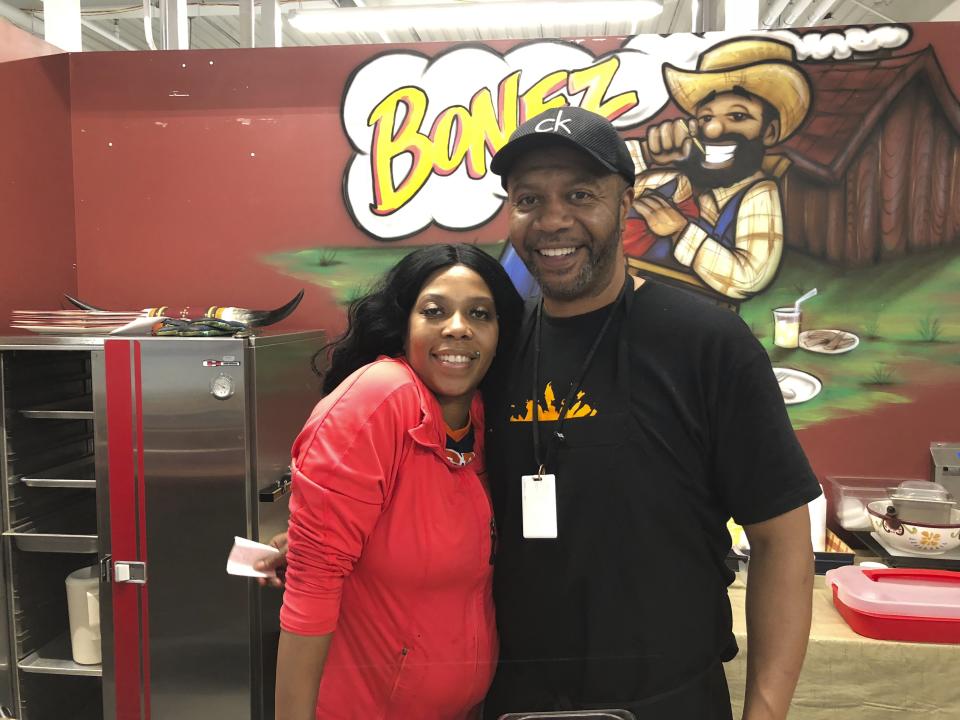 In this July 17, 2019 photo, Denise Anderson and her brother Mike Ford are seen in the a soul food booth they run at the SVRC Marketplace in Saginaw Michigan. Anderson says she hasn't personally seen benefits from the improved economy and she opposes President Donald Trump. Economic conditions in Michigan could be crucial in determining whether Democrats retake a state they once held for decades (AP Photo/Sara Burnett)