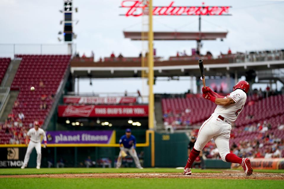 Cincinnati Reds left fielder Tommy Pham (28) hits a RBI single in the third inning during a baseball game against the Chicago Cubs, Wednesday, May 25, 2022, at Great American Ball Park in Cincinnati. 