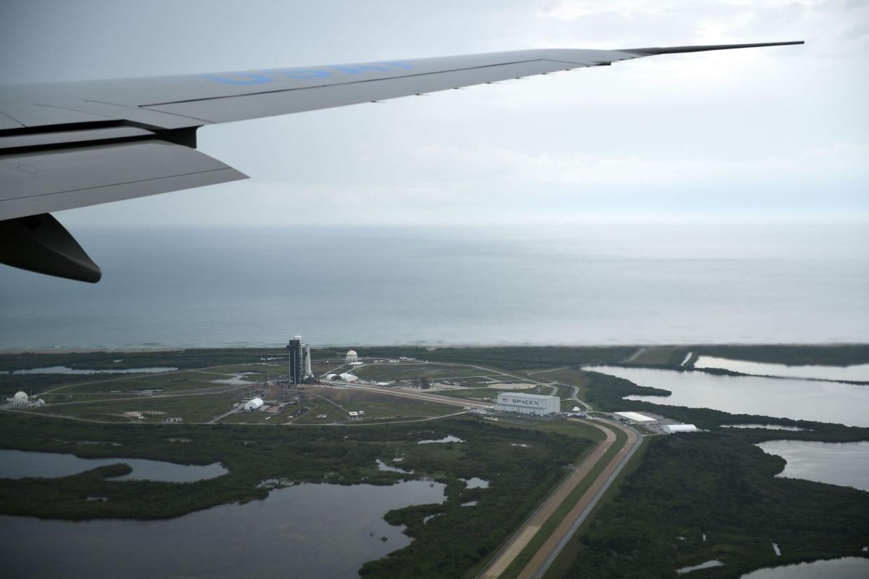 Air Force One flies over Launch pad 39A (L) and the SpaceX facility (R) at Kennedy Space Center in Florida as US President Donald Trump arrives on May 27, 2020: BRENDAN SMIALOWSKI/AFP via Getty Images